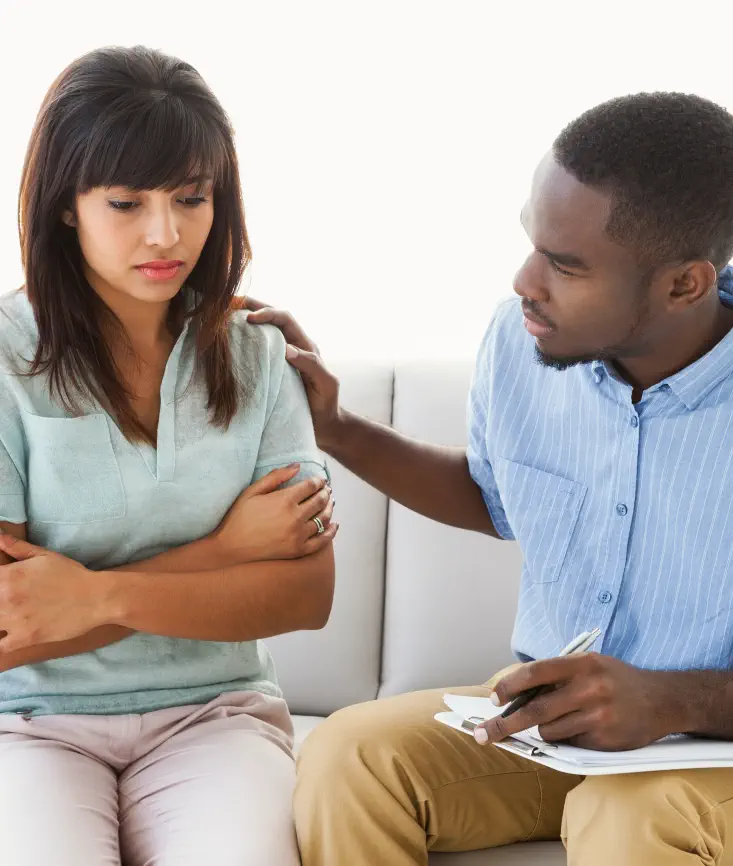 man comforting patient in therapy session