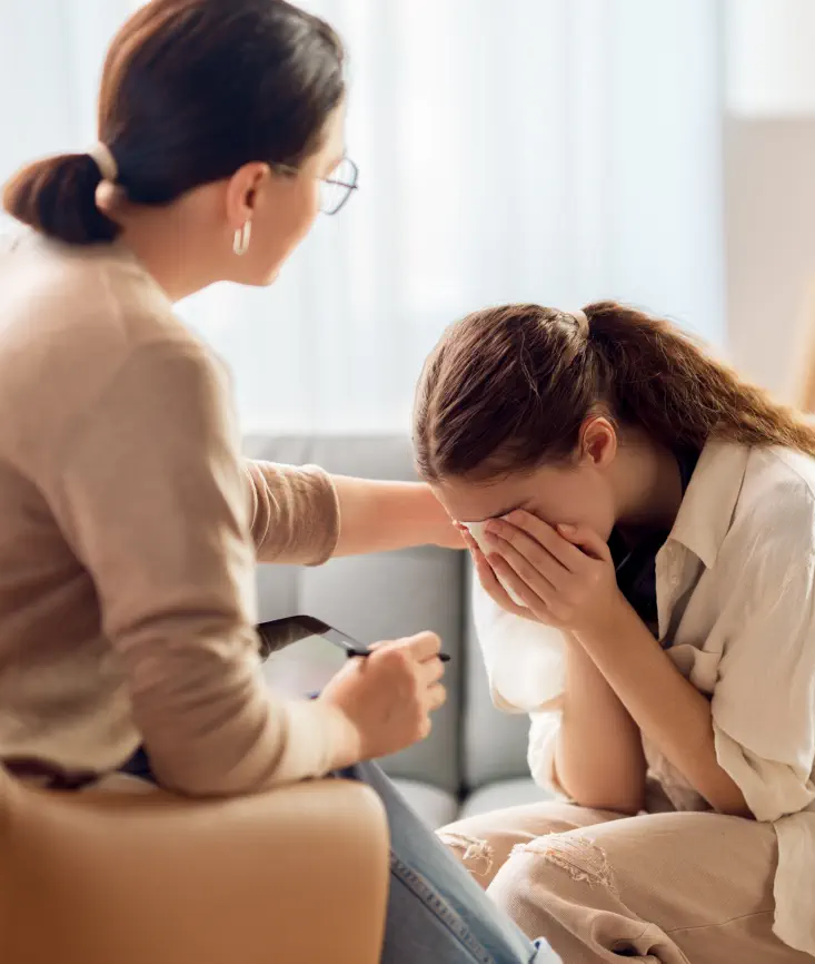 therapist comforting teen patient
