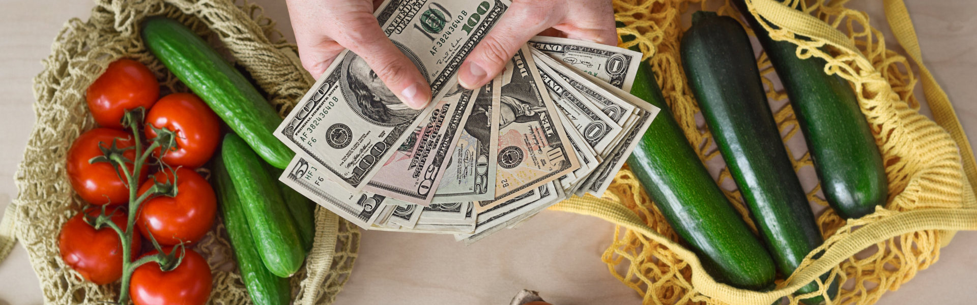 Dollars and Fresh Produce on a Wooden Table